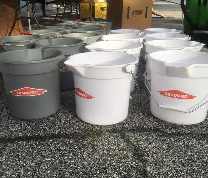 SERVPRO buckets are shown on a floor