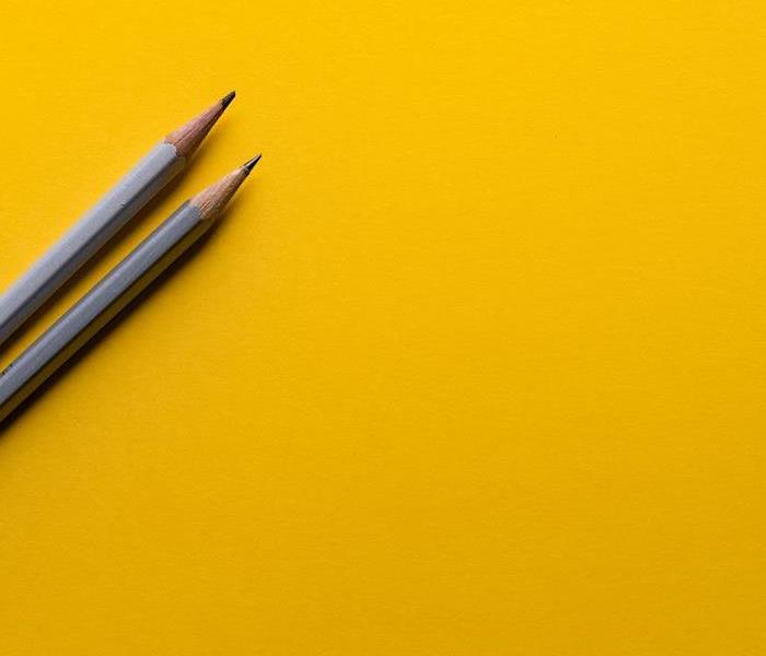 Yellow background with 2 pencils