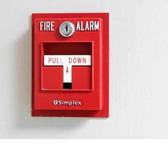 A red fire alarm pull down box is shown 